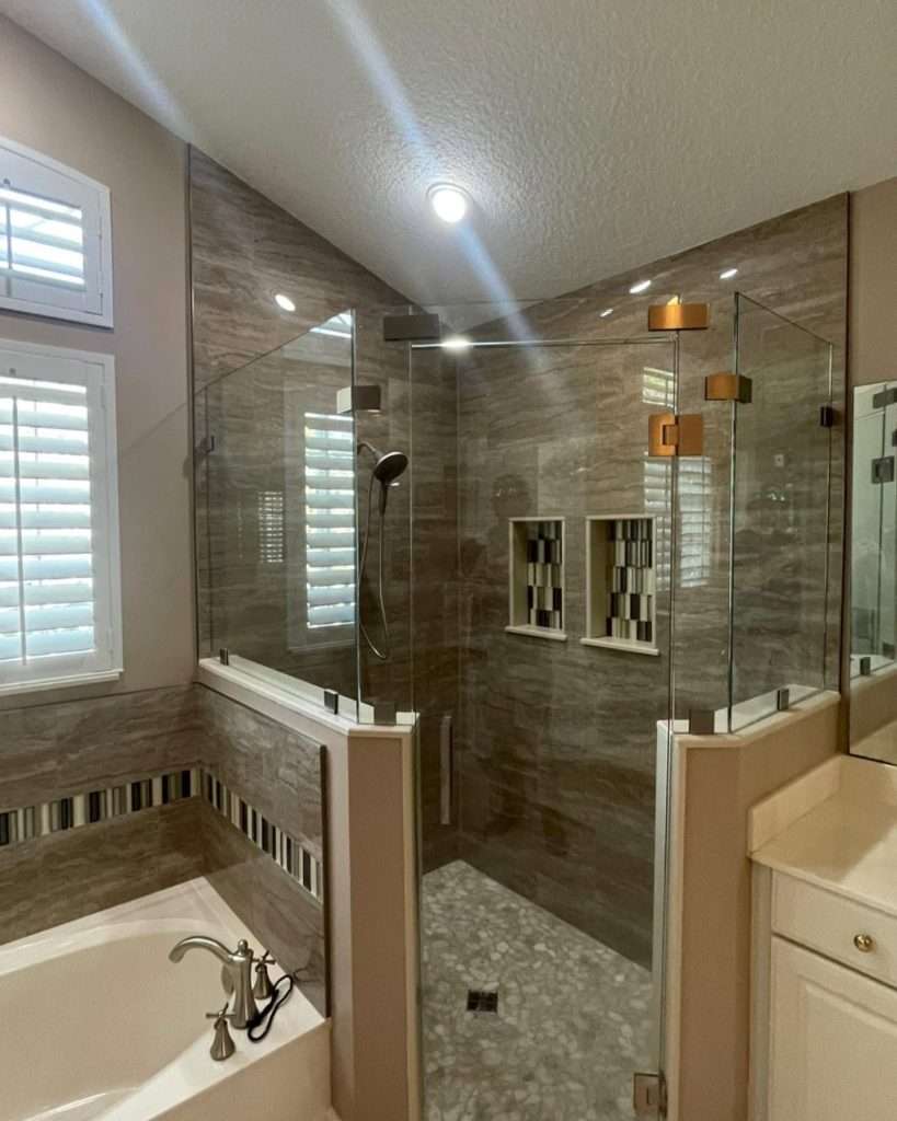 Modern tiled bathroom with glass shower and soaking tub